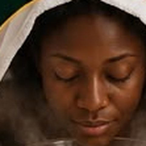 Client enjoying a herbal facial steam